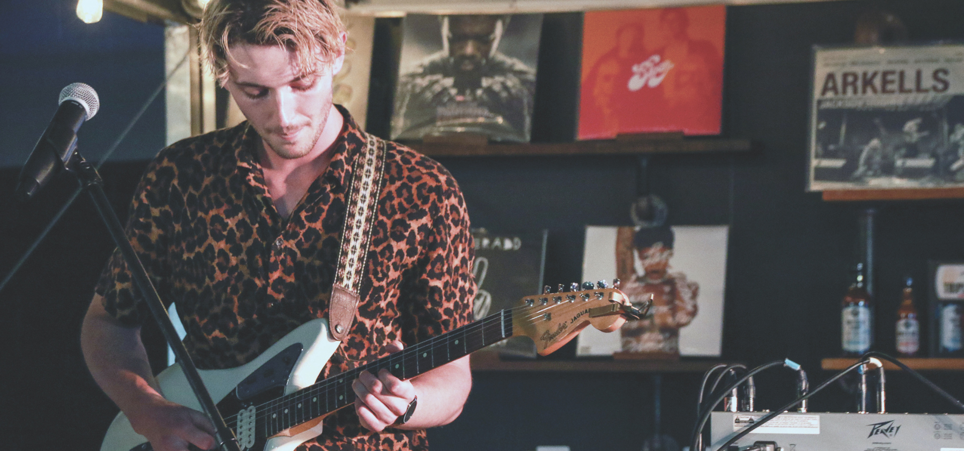 Musician strumming a guitar.