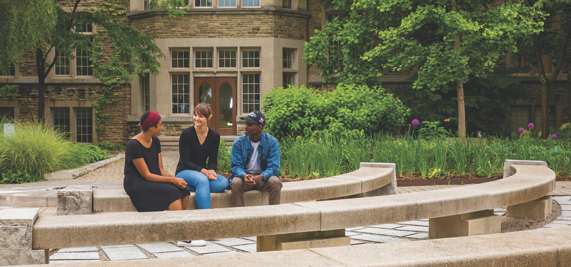 Post secondary schools sitting outside talking.