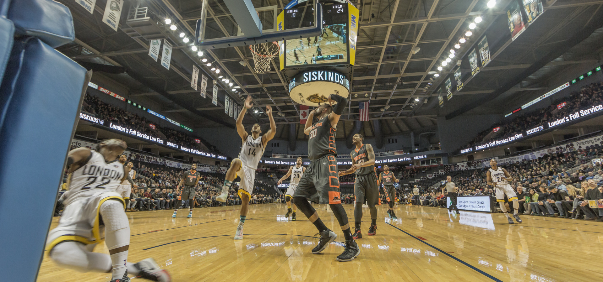 Basketball players playing a game.