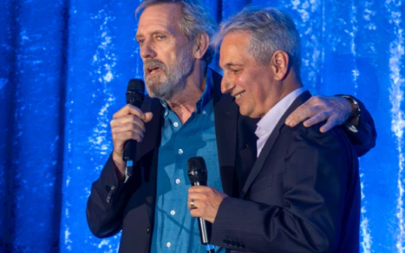Hugh Laurie, best known for his starring role on the TV show House, puts his arm around London native David Shore, the show's creator who was given a lifetime achievement award at a Forest City Film Festival gala in London on Oct. 30, 2025. Mike Hensen/The London Free Press