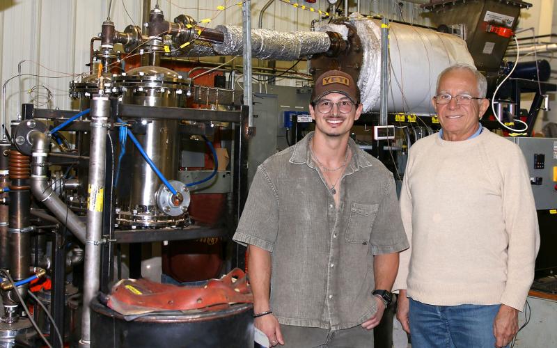 Western researchers have developed a breakthrough technology that converts agricultural waste into biochar engineered for use in a wide range of industries. The additive enriches soil, filters contaminants and locks away carbon for centuries. (L to R) Postdoctoral researcher Stephanos Horvers and chemical engineering professor Franco Berruti demonstrate their experimental reactor that led to a startup company, ITER Technologies. (Colleen MacDonald/Western News)