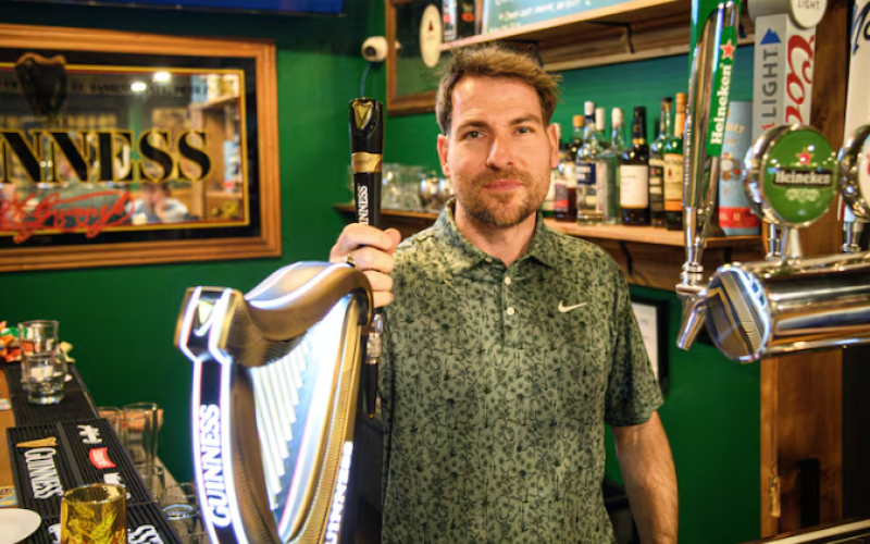 Michael Holden poses at the bar of his new Irish pub, The Off Licence Pub in London, Ont., on Jan. 17, 2026. (Matthew Trevithick/CBC)