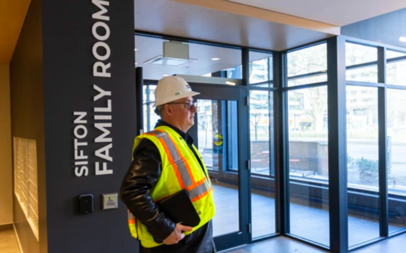 Sifton’s Rick Gooyers walks through ground-floor community spaces at 195 Dufferin. Photograph taken Wednesday, March 25, 2026. (Mike Hensen/The London Free Press)