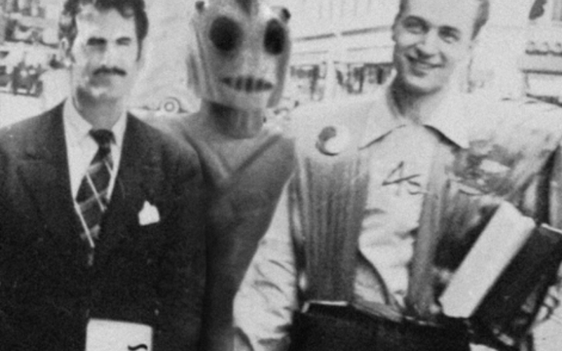 A box of old items collected by Londoner Sam McCoy from the early days of sci-fi conventions is the inspiration for the film The Box, The Con And The Handsomest Man In Fandom. It included this photo of Forrest Ackerman, right, a famous sci-fi magazine editor, at a 1939 sci-fi convention in New York, posing with an alien robot and an unidentified man in an early example of convention cosplay. 