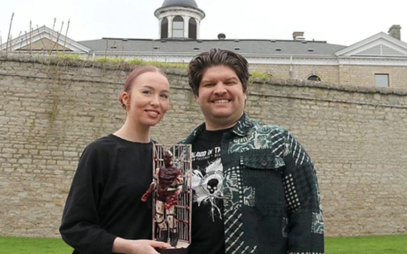 The horror movie Fresh Meat, filmed in the old Chatham Jail, will be marketed at the Cannes Film Market in France from May 12 to 20. Fresh Meat creator and director Daniel Turres and his partner Whitney Archer, who was art director on the film, are seen here with a figurine of The Inmate, named Jeffery, created by Chatham artist Mike Thain, known as the 'Toy Butcher.' (Ellwood Shreve/Chatham Daily News)