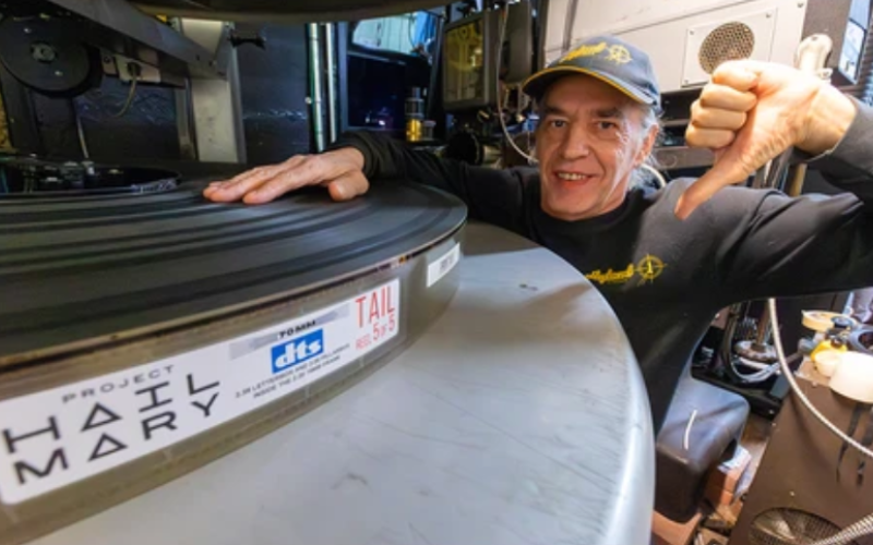 Hyland Cinema projectionist Victor Liorentas gives a thumbs down in reference to the film Project Hail Mary while holding a rare 70mm reel of the movie starring London-born actor Ryan Gosling. Photograph taken Tuesday, May 12, 2026. (Mike Hensen/The London Free Press)