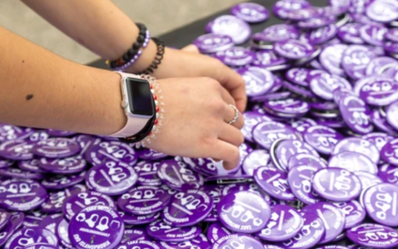 Sophia Abdulkarim, 13, sorts through Our London Family buttons at Oakridge secondary school in London, where a march began to mark the one-year anniversary of the hate-motivated killings of the Afzaal family. Photograph taken on Sunday, June 5, 2022. (Mike Hensen/The London Free Press)