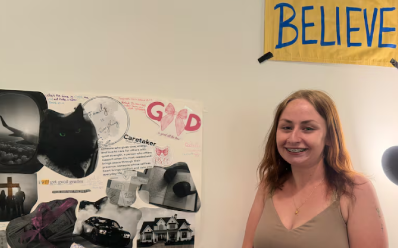 Lenore Felts, 20, stands in front of a vision board she created for her future. Felts is among 27 students part of the Connecting Futures program in London, Ont. that reconnects youth in and from the child welfare system back to educational pathways. For Felts, that's allowed her to soon graduate high school and attend college. (Isha Bhargava/CBC)