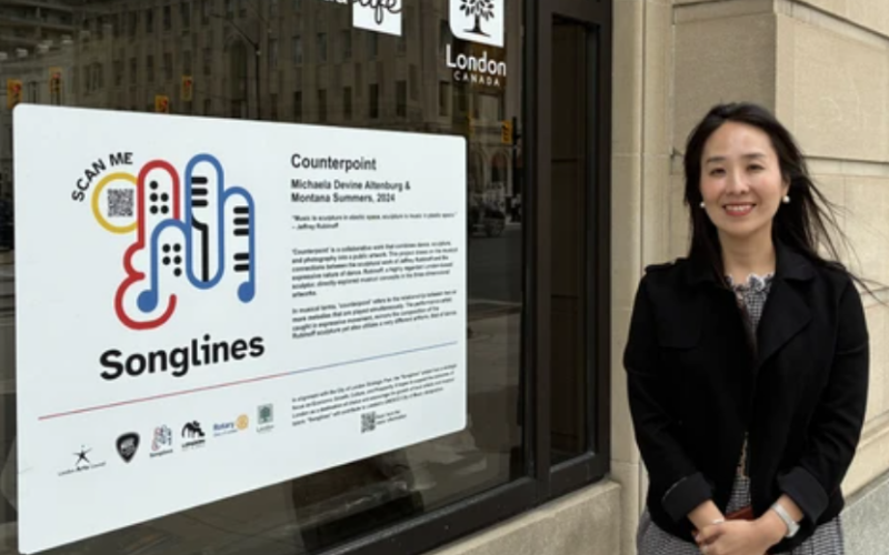 London Arts Council executive director Eunji Yi stands in front of the Songlines installment at the J. Allyn Taylor building in downtown London on Thursday, June 18, 2026. Allison Young/ The London Free Press