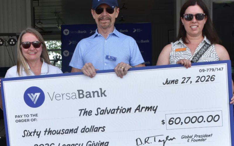 VersaBank Founder and President David Taylor (centre) presents a cheque to Nancy Kerr of The Salvation Army’s London Community Services (left) and Carrie Ford, Grant Writer, The Salvation Army Canada (right) at VersaBank’s Summer Celebration event in London, Ont., on Saturday, June 27, 2026. (Source: Submitted)