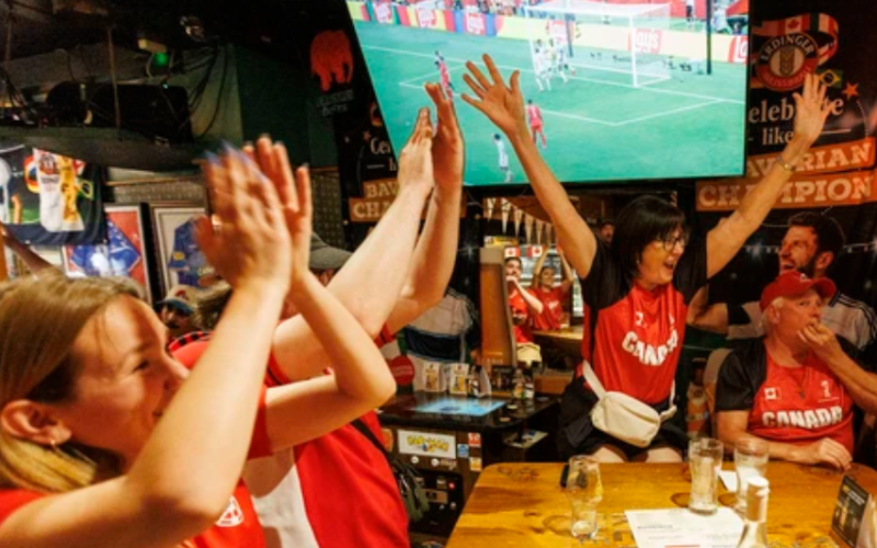 Maryann Charron (centre) cheers Canada’s goal while watching the World Cup match against Switzerland at The Scot’s Corner in London on Wednesday, June 24, 2026. (Geoff Robins/The London Free Press)