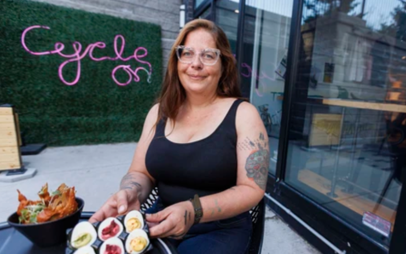 Alicia Berkelmans, chef at the London Bicycle Cafe, poses with some of the cafe’s fare in London on Monday, July 13, 2026. The cafe has earned Feast On certification for featuring ingredients grown and made in Ontario. (Geoff Robins/The London Free Press)