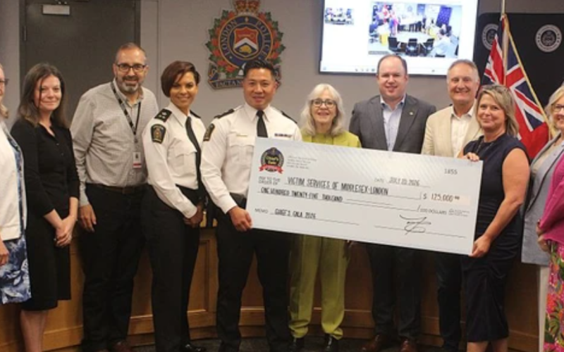 London police Chief Thai Truong, centre, presents a cheque to officials from Victim Services of Middlesex London on Monday, July 20, 2026. (Dale Carruthers/The London Free Press)