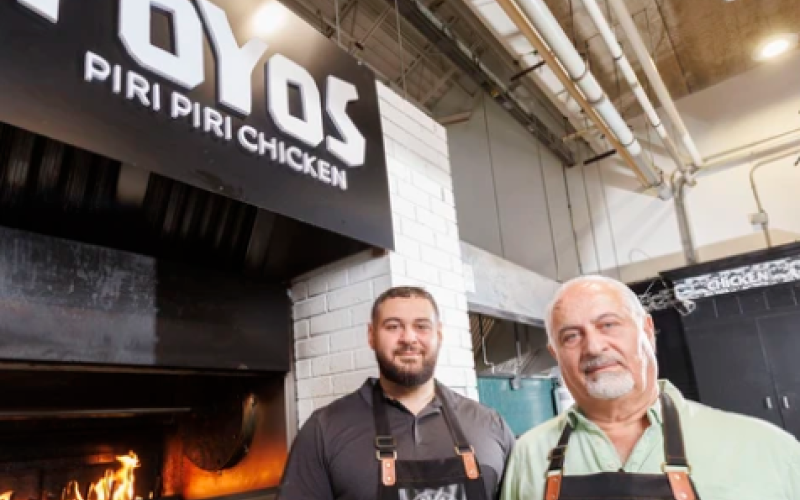 Ferras Hayek and his father, Ahmad Hayek, pose at their restaurant, Poyos & Kaftas, in Covent Garden Market in London on Monday, Aug. 10, 2026. (Geoff Robins/The London Free Press)