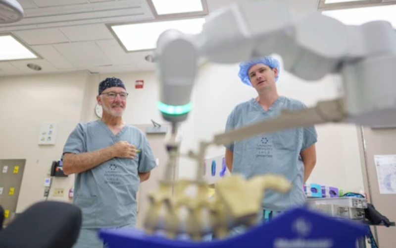 Pediatric surgeons Dr. Patrick Thornley, right, and Dr. Timothy Carey discuss a new robotic scoliosis procedure pioneered by Thornley in Ontario in an operating room at Victoria Hospital in London on Thursday, Aug. 13, 2026. (Geoff Robins/The London Free Press)