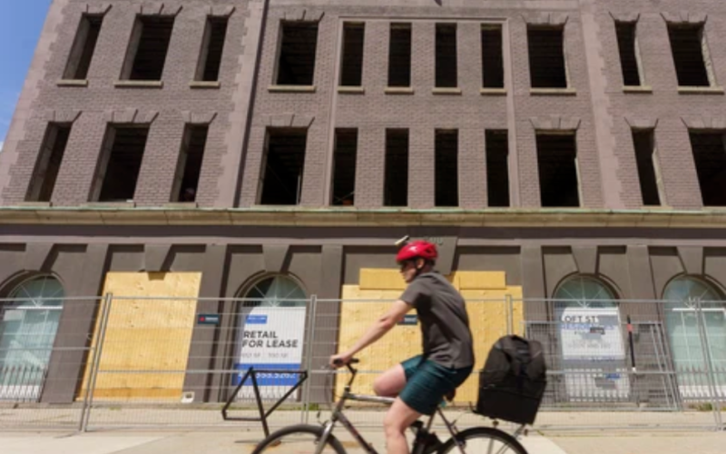 A cyclist rides by 300 Dundas Street in London on Wednesday, August 19, 2026. (Geoff Robins/The London Free Press)