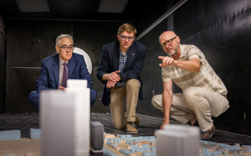 Western engineering dean Ken Coley, Western’s new Eddie Goldenberg Research Chair of Canada in Climate Risk and Resilience Analytics Seth Guikema and ImpactWX Chair in Severe Storms Engineering Greg Kopp visit the Boundary Layer Wind Tunnel Laboratory. (Steve Anderson / Western Communications)