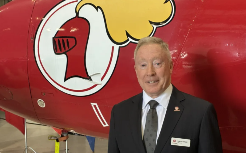 Fanshawe College president Peter Devlin poses beside the Red Knight, a Canadian aerobatic aircraft that flew from 1958 to 1969, at the college’s Norton Wolf School of Aerospace, Information and Defence Technologies in London on Friday, Oct. 2, 2026. (Norman De Bono/The London Free Press)