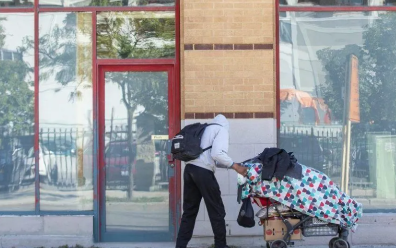 A man pushes his belongings along Clarence Street in London on Wednesday, Oct. 5, 2022. (Free Press files)